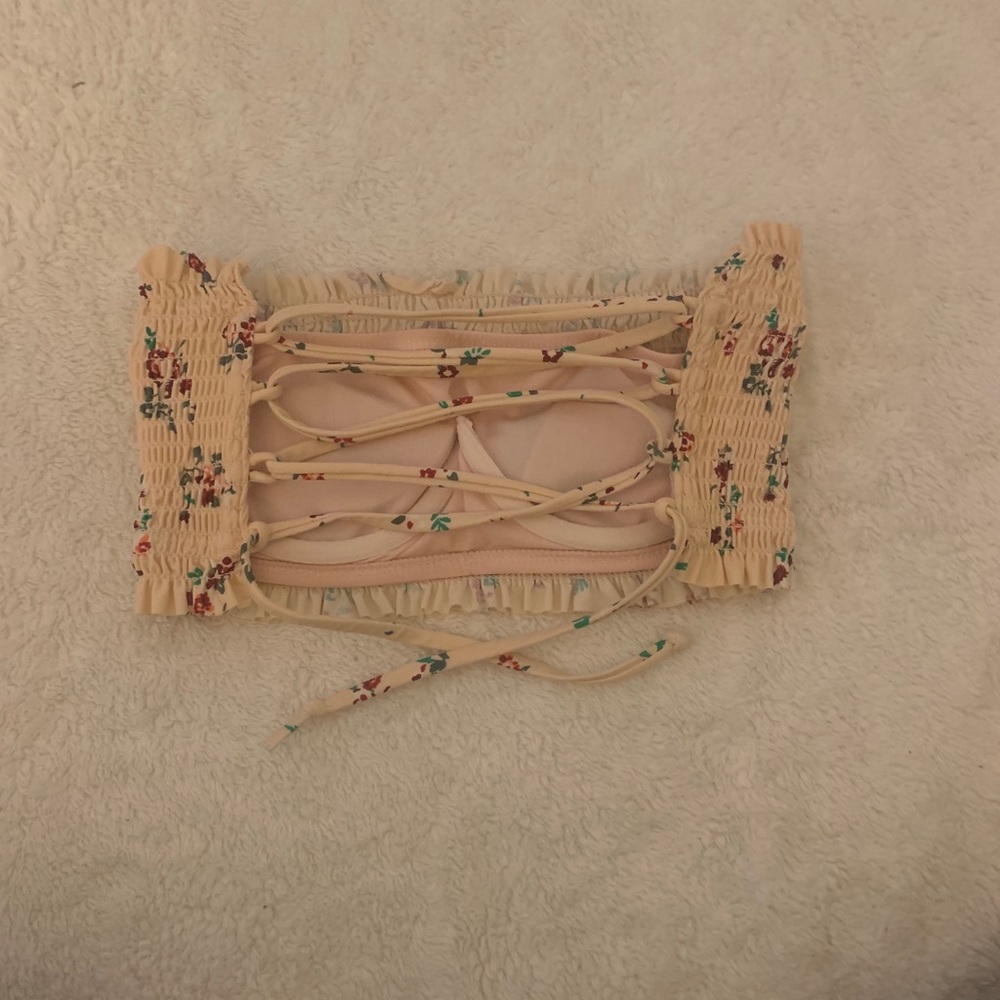 A pink strapless swimsuit top